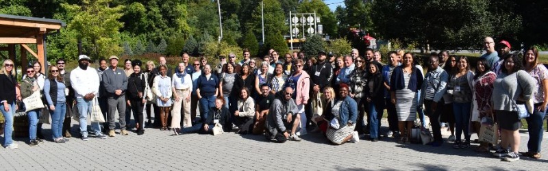 group of people standing in a backyard